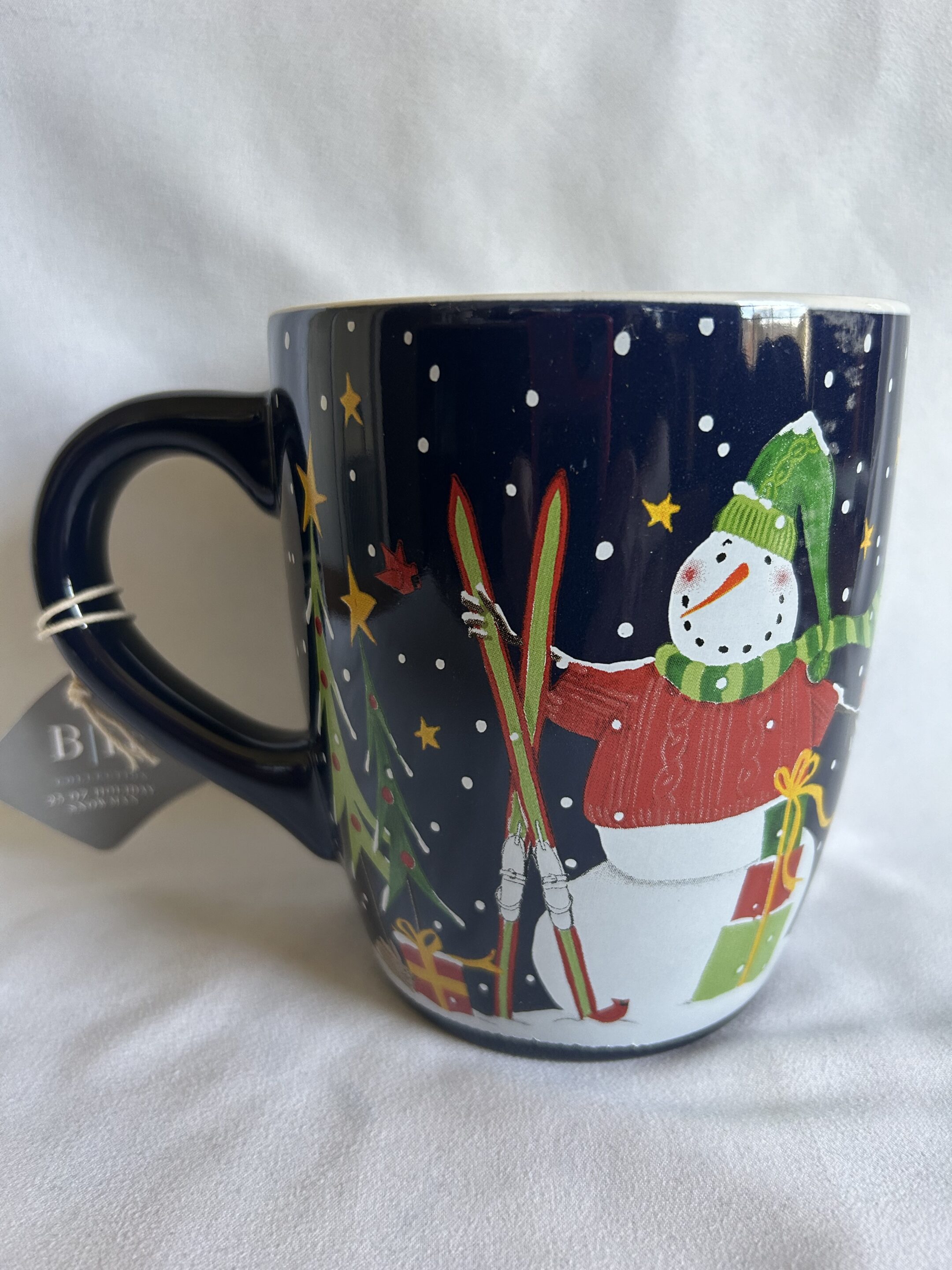25oz Blue Snowman Holding Skis Mug | Green Valley Book Fair