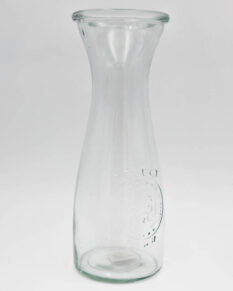 A glass carafe with the words "Select Farm" and a rooster seal.
