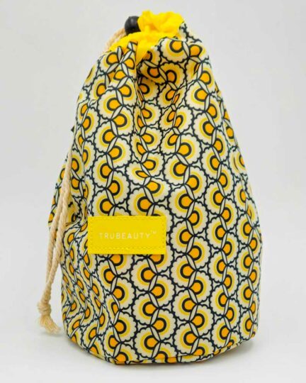 Yellow, white, and black patterned drawstring cosmetic bag.