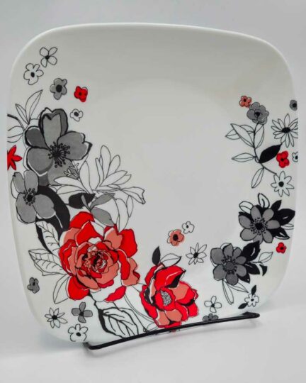 9-inch Corelle salad plate with greyscale and red flowers.